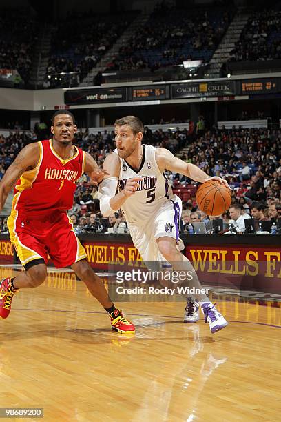 Andres Nocioni of the Sacramento Kings drives around Trevor Ariza the Houston Rockets at Arco Arena on April 12, 2010 in Sacramento, California. The...