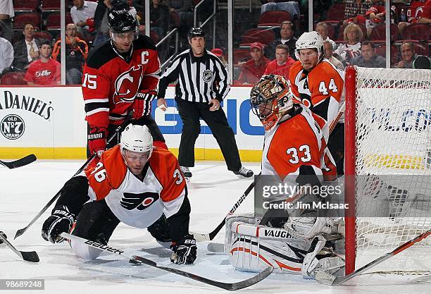 Brian Boucher and Darroll Powe of the Philadelphia Flyers defend against the New Jersey Devils in Game 5 of the Eastern Conference Quarterfinals...