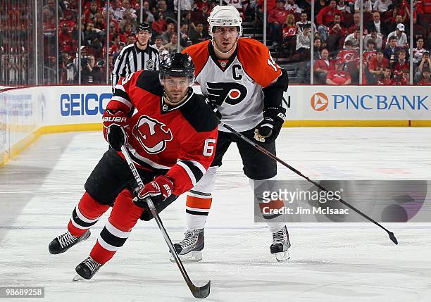 Andy Greene of the New Jersey Devils skates against Mike Richards of the Philadelphia Flyers in Game 5 of the Eastern Conference Quarterfinals during...