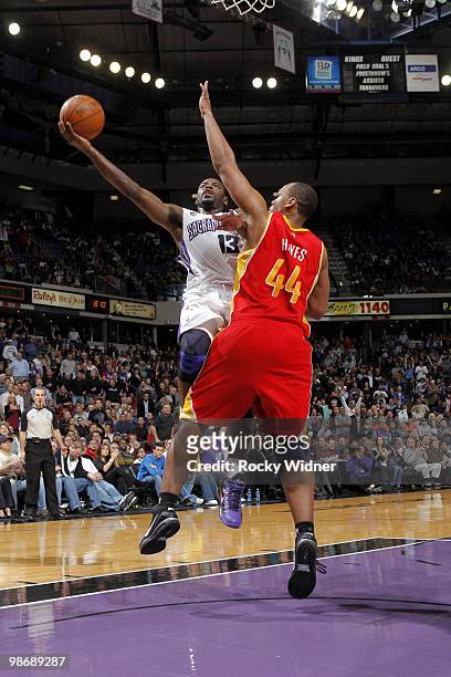 Tyreke Evans of the Sacramento Kings shoots a layup around over Chuck Hayes of the Houston Rockets at Arco Arena on April 12, 2010 in Sacramento,...