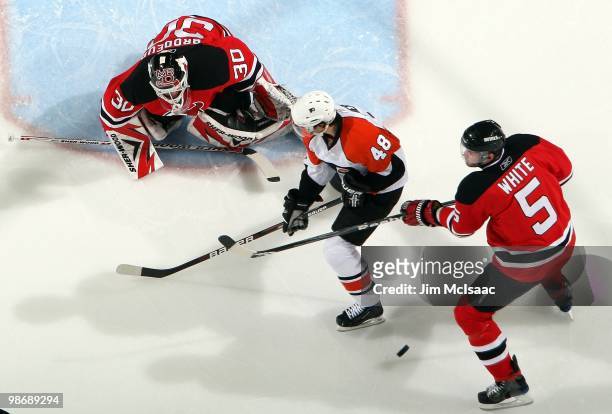 Martin Brodeur and Colin White of the New Jersey Devils defend against Daniel Briere of the Philadelphia Flyers in Game 5 of the Eastern Conference...