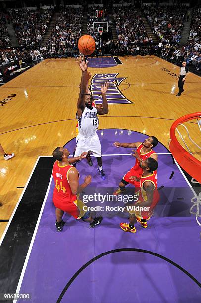 Tyreke Evans of the Sacramento Kings shoots over Chuck Hayes, Trevor Ariza and Aaron Brooks of the Houston Rockets at Arco Arena on April 12, 2010 in...