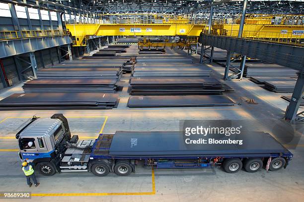 Quality inspector speaks with a truck driver before shipping steel seats at Hyundai Steel Co.'s plant in Dangjin, South Korea, on Friday, April 23,...