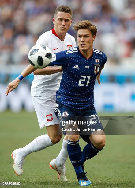 Sakai Gotoku of Japan holds off Piotr Zielinski of Poland during the 2018 FIFA World Cup Russia group H match between Japan and Poland at Volgograd...