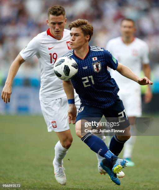 Sakai Gotoku of Japan holds off Piotr Zielinski of Poland during the 2018 FIFA World Cup Russia group H match between Japan and Poland at Volgograd...