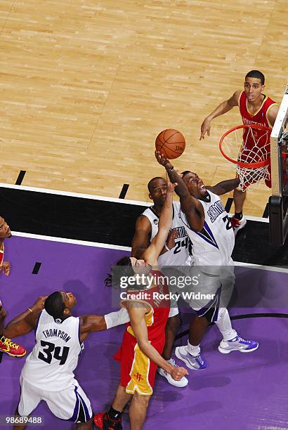 Donte Greene of the Sacramento Kings goes to the hoop with contact from Luis Scola of the Houston Rockets at Arco Arena on April 12, 2010 in...