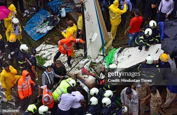 Forensic experts, fire department personnel and a dog squad inspect the wreckage of Beechcraft King Air C90 turboprop at Old Malik Estate, Jeev Daya...