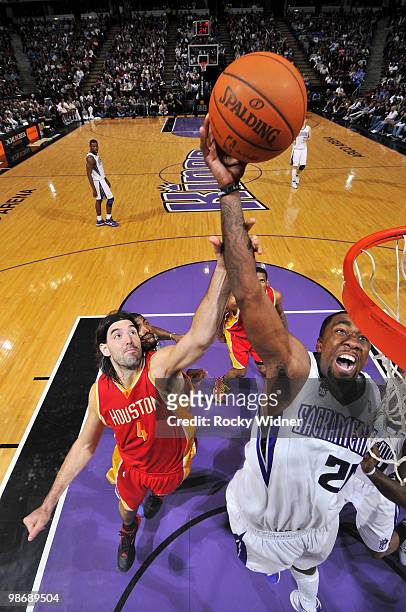 Donte Greene of the Sacramento Kings goes to the hoop with contact from Luis Scola of the Houston Rockets at Arco Arena on April 12, 2010 in...