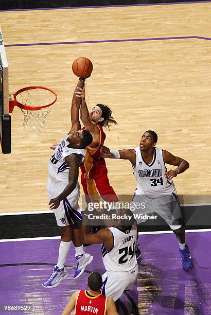 Donte Greene of the Sacramento Kings goes to the hoop with contact from Luis Scola of the Houston Rockets at Arco Arena on April 12, 2010 in...