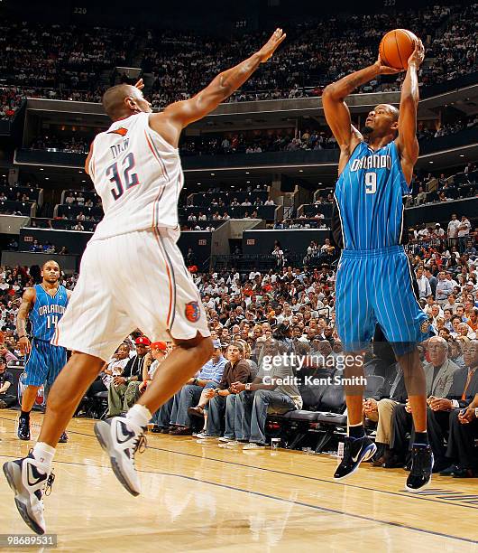 Rashard Lewis of the Orlando Magic shoots over a charging Boris Diaw of the Charlotte Bobcats in Game Four of the Eastern Conference Quarterfinals...