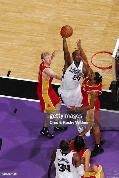 Carl Landry of the Sacramento Kings hooks a shot between Jared Jeffries and Chase Budinger of the Houston Rockets at Arco Arena on April 12, 2010 in...