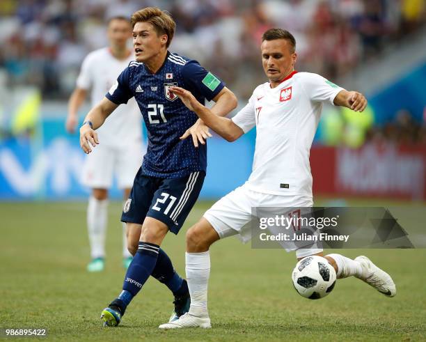 Gotoku Sakai of Japan battles with Slawomir Peszko of Poland during the 2018 FIFA World Cup Russia group H match between Japan and Poland at...