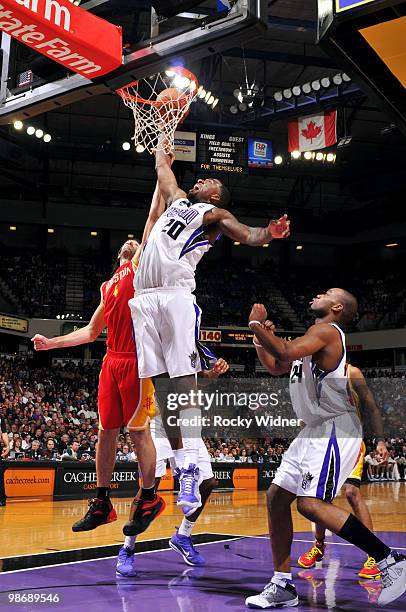 Donte Greene of the Sacramento Kings goes to the hoop with contact from Luis Scola of the Houston Rockets at Arco Arena on April 12, 2010 in...