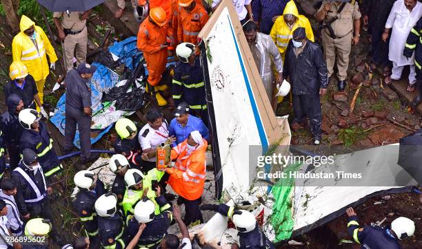 Forensic experts, fire department personnel and a dog squad inspect the wreckage of Beechcraft King Air C90 turboprop at Old Malik Estate, Jeev Daya...