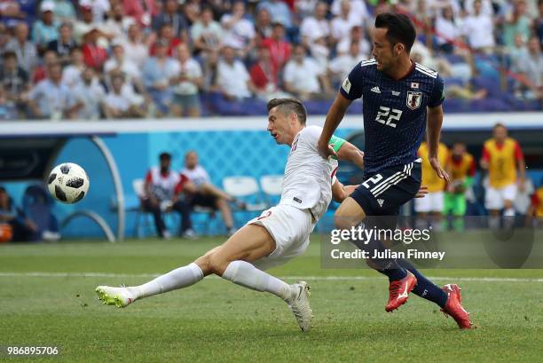 Robert Lewandowski of Poland shoots over under pressure from Maya Yoshida of Japan during the 2018 FIFA World Cup Russia group H match between Japan...