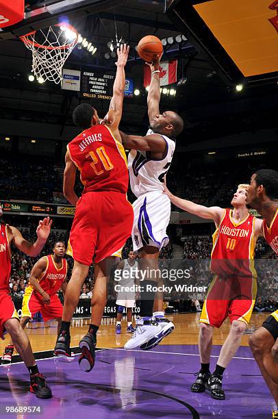 Carl Landry of the Sacramento Kings hooks a shot between Jared Jeffries and Chase Budinger of the Houston Rockets at Arco Arena on April 12, 2010 in...