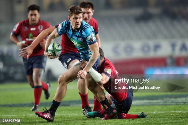 Blues Matt Duffie is tackled by the Reds defence during the round 17 Super Rugby match between the Blues and the Reds at Eden Park on June 29, 2018...