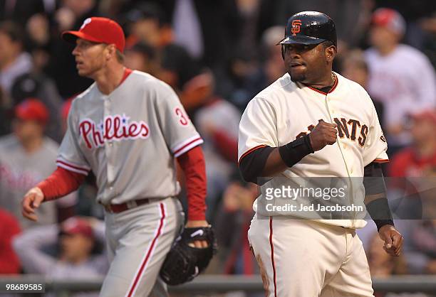 Pablo Sandoval of the San Francisco Giants celebrates after scoring on a Mark DeRosa single in the first inning as Roy Halladay of the Philadelphia...