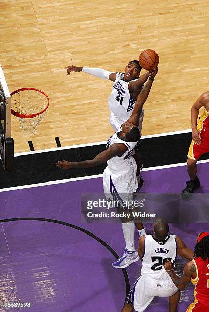 Jason Thompson and Donte Greene of the Sacramento Kings reach for a rebound during the game against the Houston Rockets at Arco Arena on April 12,...