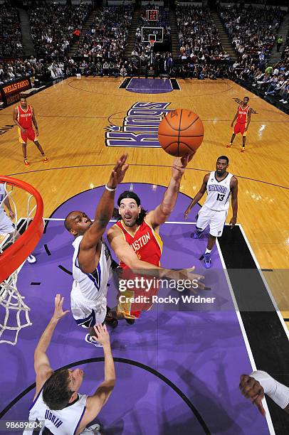 Luis Scola of the Houston Rockets hooks a shot over Carl Landry of the Sacramento Kings at Arco Arena on April 12, 2010 in Sacramento, California....