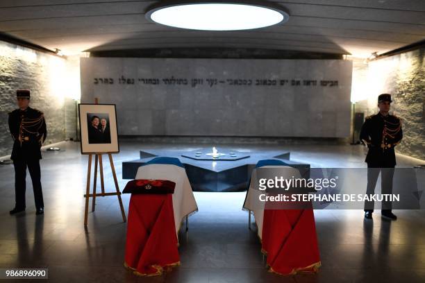 Honour guards stand next to the coffins of women's rights icon, French politician and Holocaust survivor Simone and her husband Antoine Veil drapped...