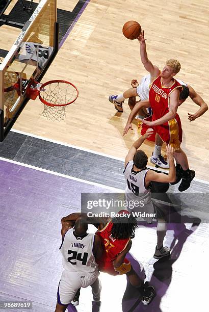 Chase Budinger of the Houston Rockets hooks a shot over Beno Udrih of the Sacramento Kings at Arco Arena on April 12, 2010 in Sacramento, California....