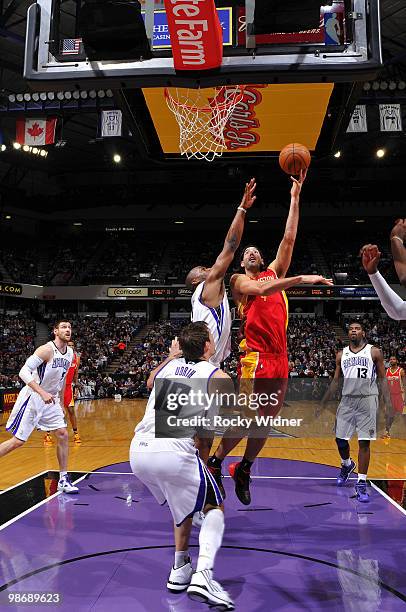 Luis Scola of the Houston Rockets hooks a shot over Carl Landry of the Sacramento Kings at Arco Arena on April 12, 2010 in Sacramento, California....