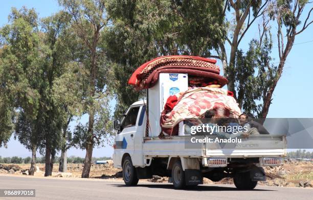 Syrian families who have been forced to flee due to the ongoing military operations by Bashar al-Assad regime and its supporters are seen journeying...