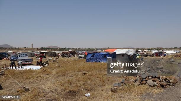 Syrian families are seen near the Golan Heights and the Israel-Jordan border after they fled from the ongoing military operations by Bashar al-Assad...