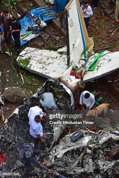 Forensic experts, fire department personnel and a dog squad inspect the wreckage of Beechcraft King Air C90 turboprop at Old Malik Estate, Jeev Daya...