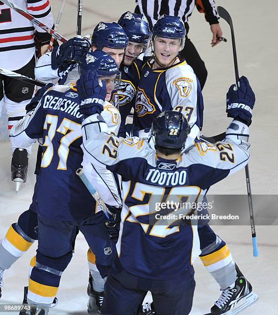 Jordin Tootoo , Denis Grebeshkov, and Colin Wilson of the Nashville Predators celebrate with teammates after scoring a goal against the Chicago...