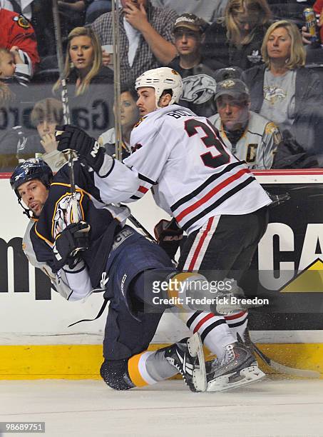 David Legwand of the Nashville Predators is checked by Dave Bolland of the Chicago Blackhawks in Game Six of the Western Conference Quarterfinals...