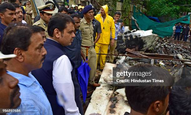 Maharastra Chief Minister Devendra Fadnavise at the chartered plane crash site inspects the wreckage of Beechcraft King Air C90 turboprop at Old...