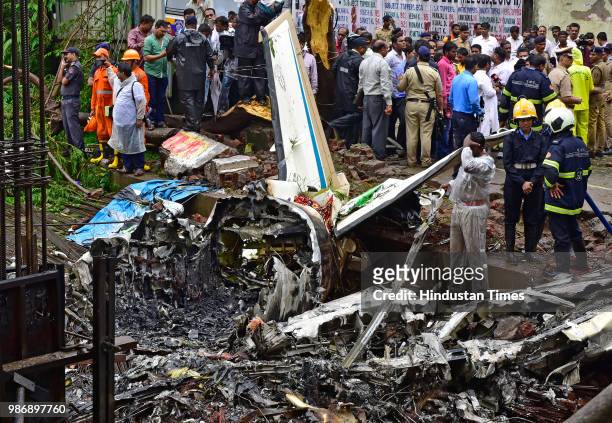 Forensic experts, fire department personnel and a dog squad inspect the wreckage of Beechcraft King Air C90 turboprop at Old Malik Estate, Jeev Daya...