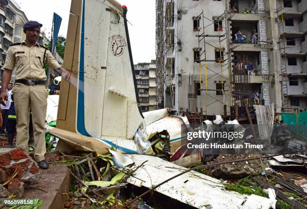 The wreckage of Beechcraft King Air C90 turboprop at Old Malik Estate, Jeev Daya Lane, near a telephone exchange at Ghatkopar , on June 28, 2018 in...