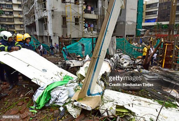 Fire department personnel inspect the wreckage of Beechcraft King Air C90 turboprop at Old Malik Estate, Jeev Daya Lane, near a telephone exchange at...
