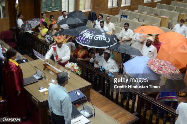 Shiv Sena, Congress and Nationalist Congress party corporator's protest with umbrella in front of Pune Mayor Mukta Tilak at General body meeting on...