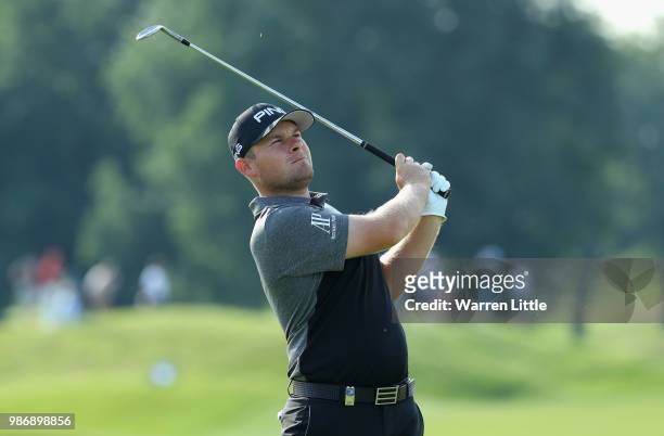 Tyrrell Hatton of England plays his second shot on the 14th hole during the second round of the HNA Open de France at Le Golf National on June 29,...