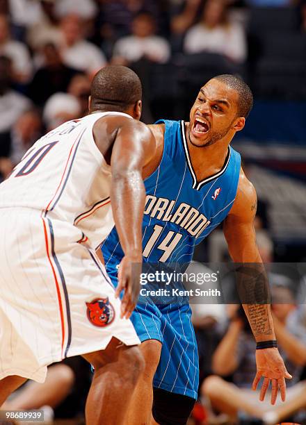 Jameer Nelson of the Orlando Magic yells to his team as Raymond Felton of the Charlotte Bobcats defends in Game Four of the Eastern Conference...