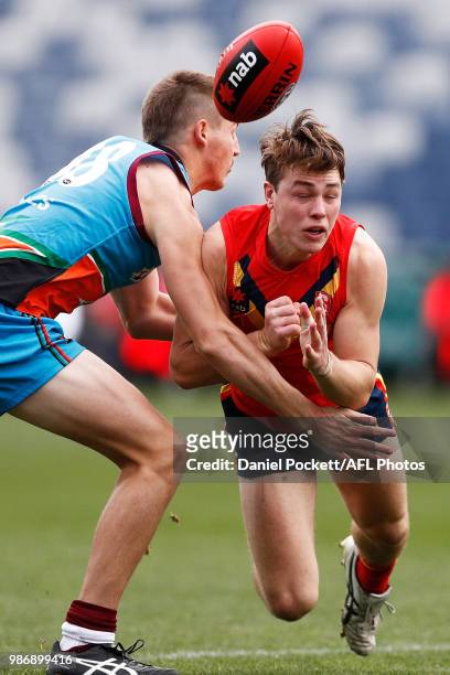 Tom Sparrow of South Australia handpasses the ball under pressure during the AFL U18 Championships match between the Allies and South Australia at...