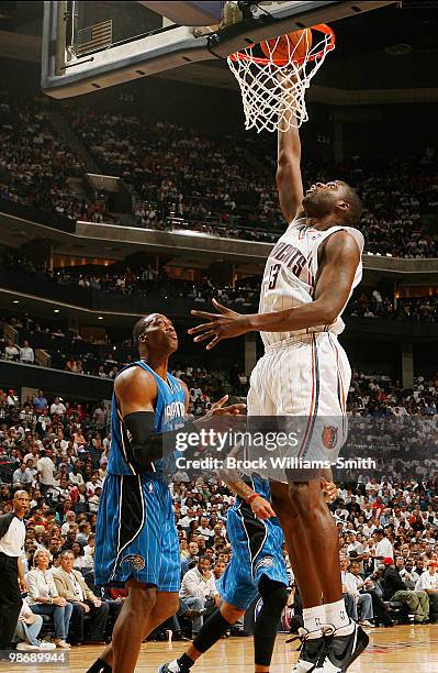 Nazr Mohammed of the Charlotte Bobcats goes for the layup as defender Dwight Howard of the Orlando Magic look son in Game Four of the Eastern...