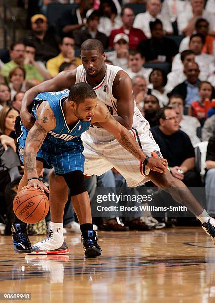 Jameer Nelson of the Orlando Magic battles against defender Raymond Felton of the Charlotte Bobcats in Game Four of the Eastern Conference...