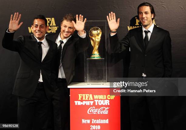 All Whites players Leo Bertos, Ben Sigmund and Ivan Vicelich pose for a photo as the FIFA World Cup trophy is displayed at the Sky City Convention...