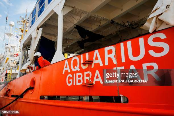 Crew member thumbs up at the deck of the Aquarius rescue vessel, chartered by French NGO SOS-Mediterranee and Doctors Without Borders at Marseille's...