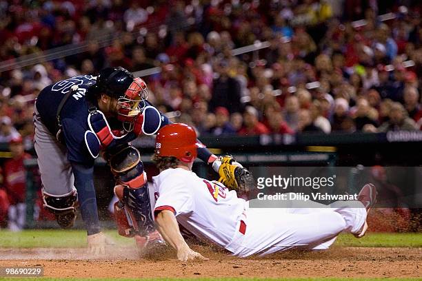 Colby Rasmus of the St. Louis Cardinals is tagged out by Brian McCann of the Atlanta Braves at Busch Stadium on April 26, 2010 in St. Louis,...