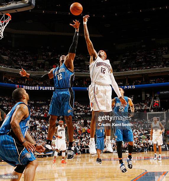 Dwight Howard of the Orlando Magic battles for a loose ball with Tyrus Thomas of the Charlotte Bobcats in Game Four of the Eastern Conference...