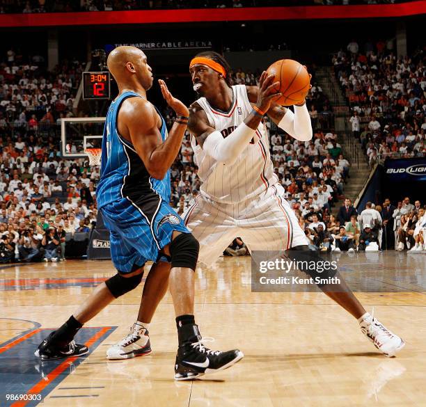 Gerald Wallace of the Charlotte Bobcats prepares to drive against Vince Carter of the Orlando Magic in Game Four of the Eastern Conference...