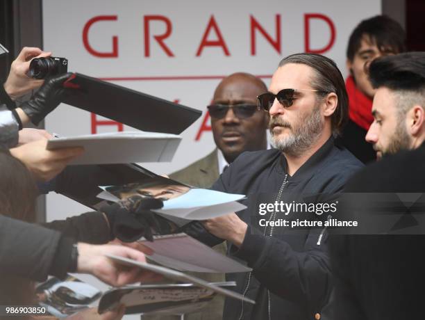 February 2018, Germany, Berlin, Berlinale, photocall, 'Don't Worry, He Won't Get Far on Foot': Actor Joaquin Phoenix gives autographs. The film runs...