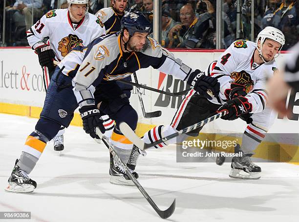 Niklas Hjalmarsson of the Chicago Blackhawks clears the puck against David Legwand of the Nashville Predators in Game Six of the Western Conference...