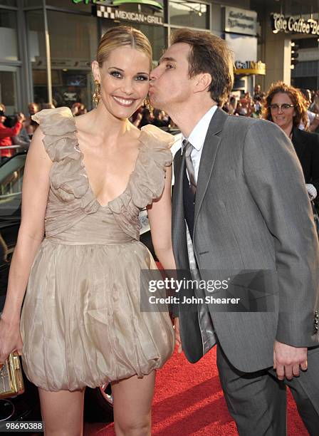 Actress Leslie Bibb and Actor Sam Rockwell pose in front of an Audi on the red carpet of the "Iron Man 2" World Premiere at the El Capitan Theatre on...